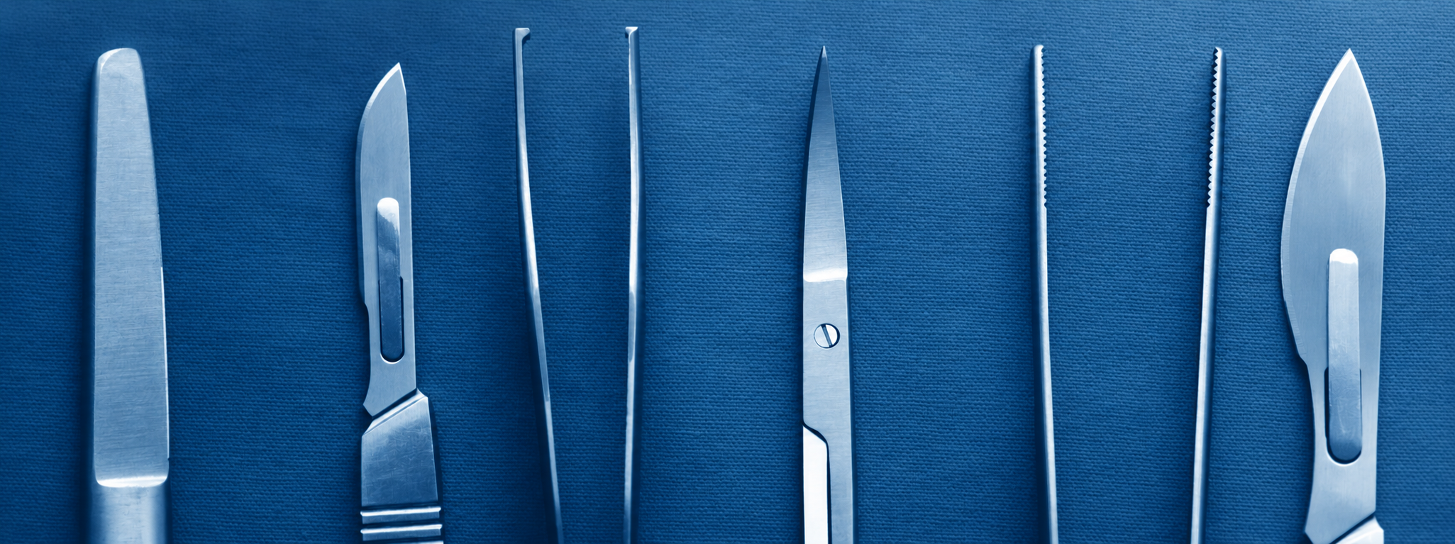 Surgical instruments arranged on a deep blue sterile drape